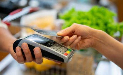 Many people say compulsory income management causes them difficulty A card is scanned at a checkout. Stock image